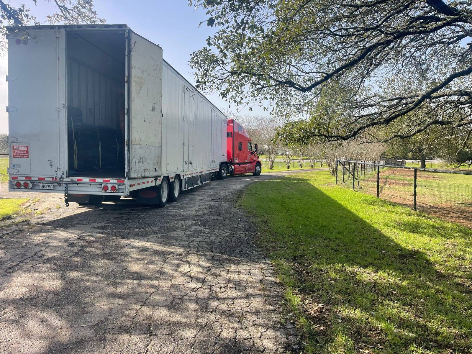 Moving On trailer open and backed up to a home during a delivery