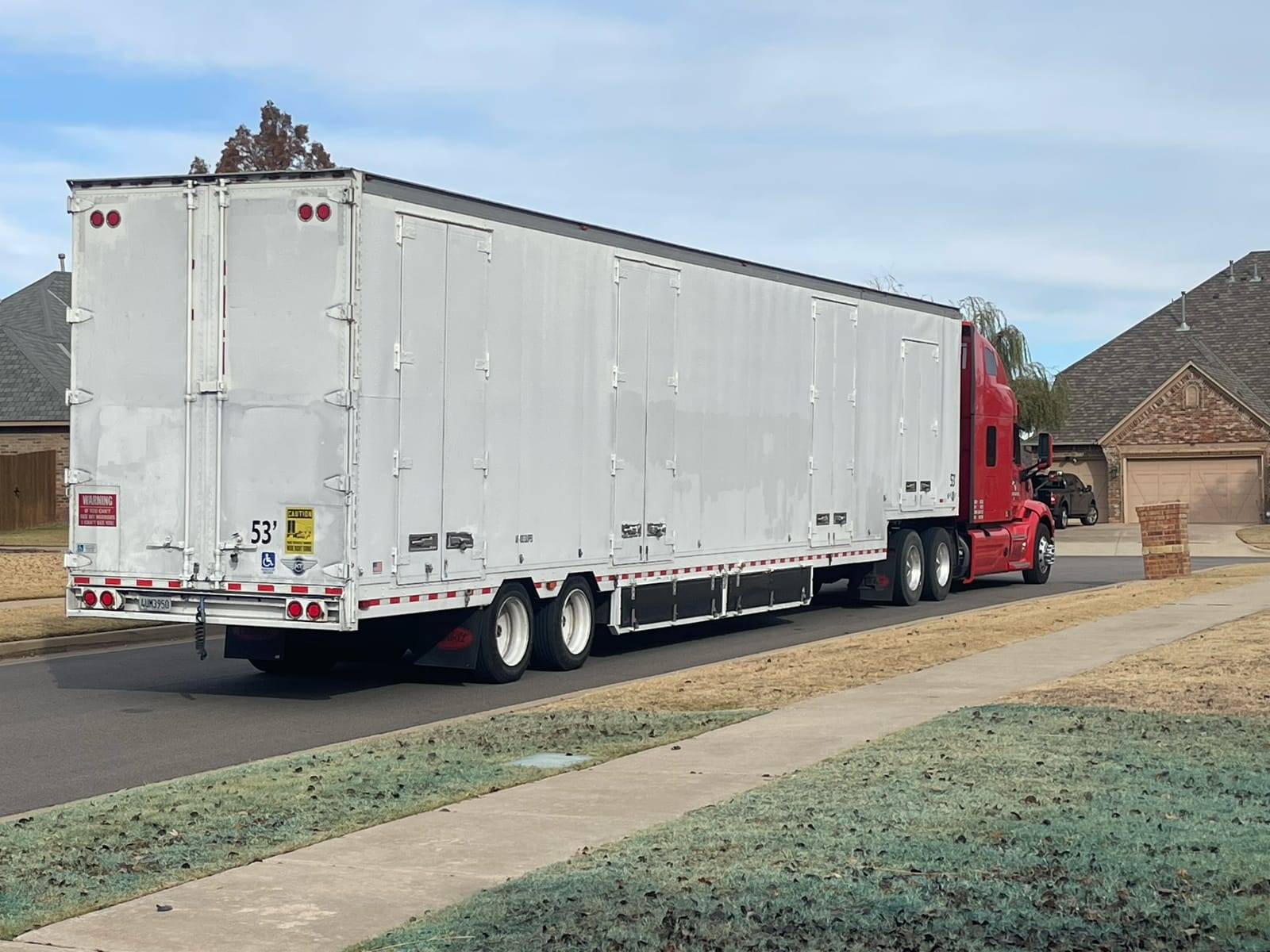 Moving On 53-foot moving trailer parked on a residential street