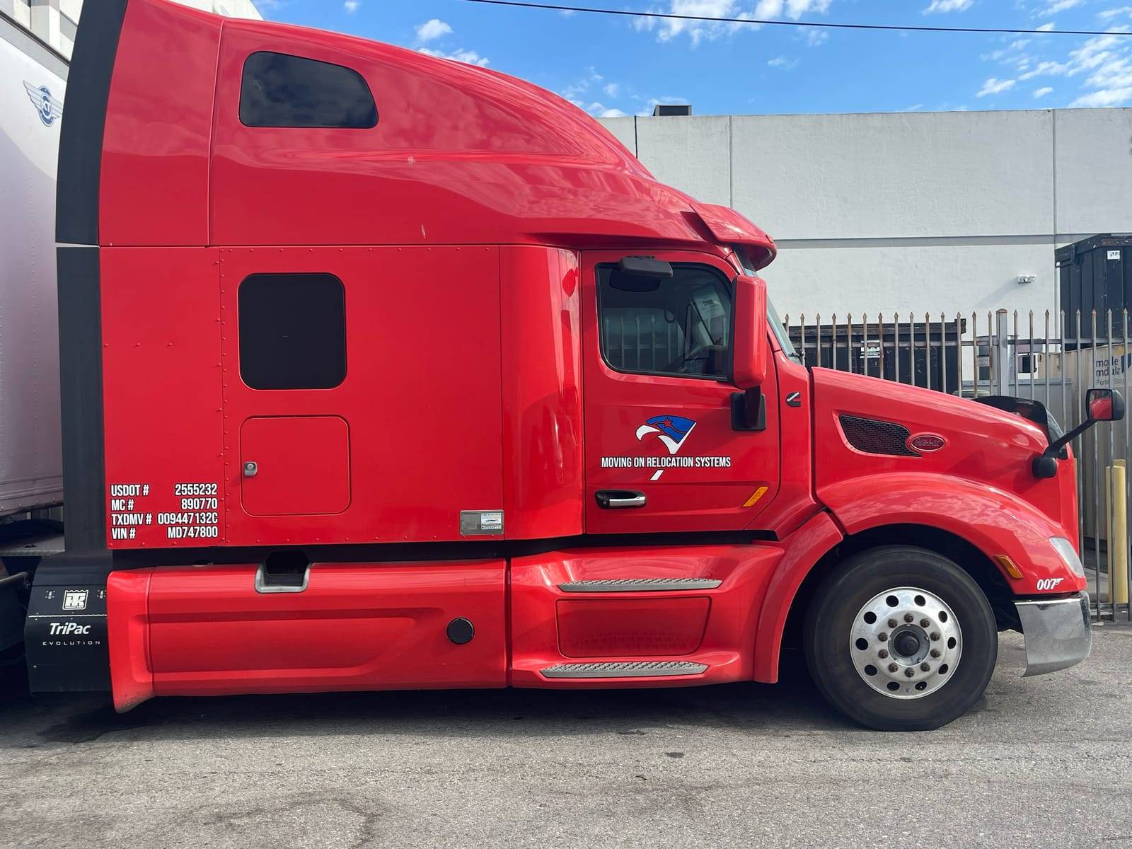 Moving On Relocation Systems truck cab showing the company logo, USDOT 2555232 and MC 890770